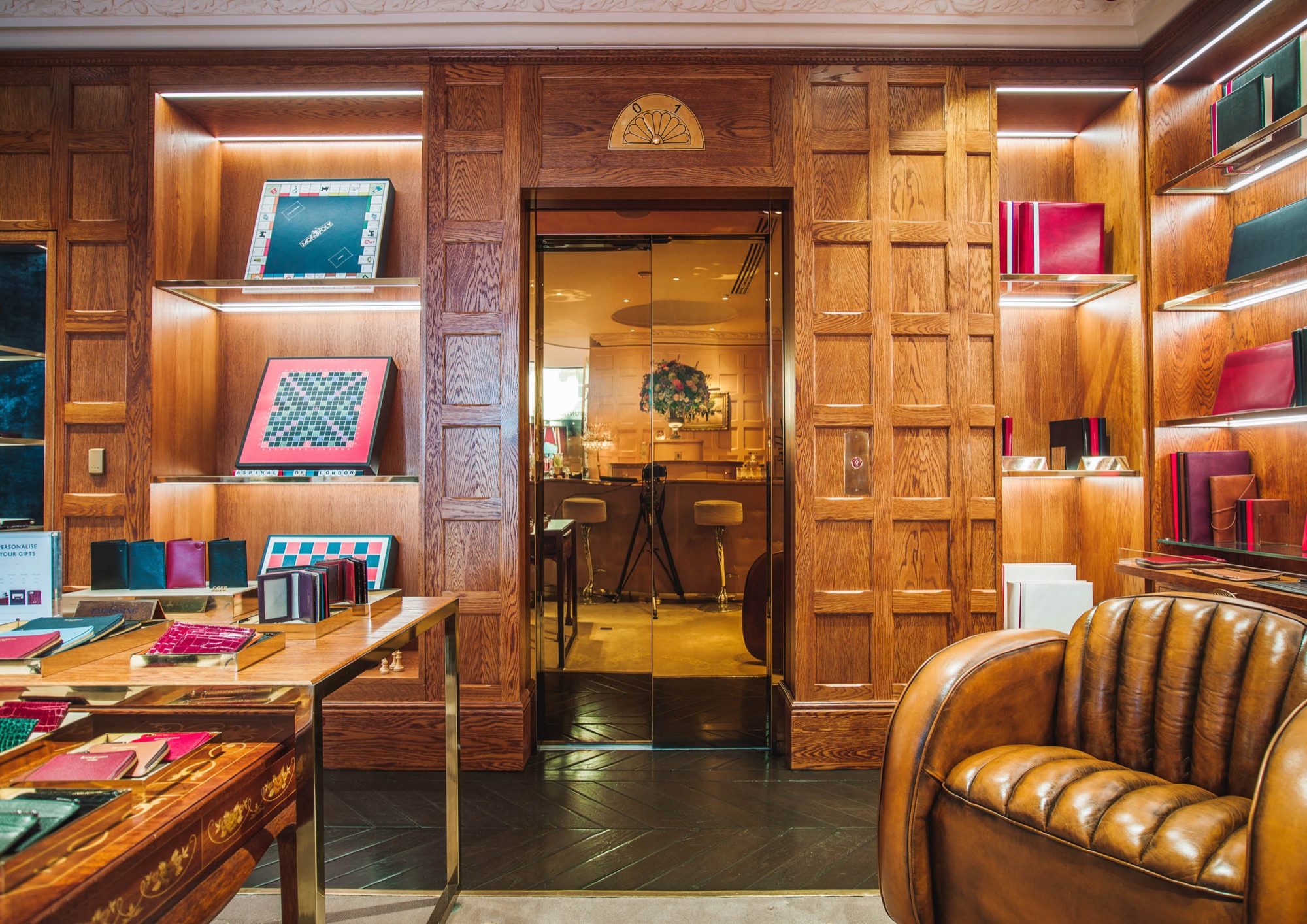 Bespoke public lift in the Aspinal of London store, set in walnut panelling